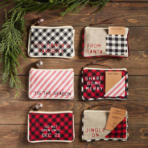 Dress up your Christmas gift with our Do Not Open Gift Pouch. The canvas and flannel zipper pouch features a buffalo check pattern. The pouch features a black and red pattern and the sentiment "Do not open until Dec. 25". The pouch also has a jingle bell zipper accent.